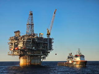 Offshore supply vessel alongside an offshore production platform