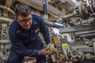 Engineman repairing a shipboard reverse osmosis watermaker