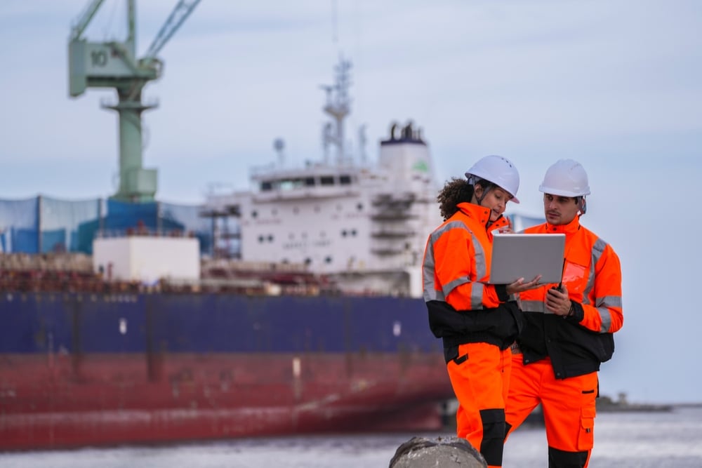 two-marine-engineers-wearing-safety-gear two-marine-engineers-wearing-safety-gear